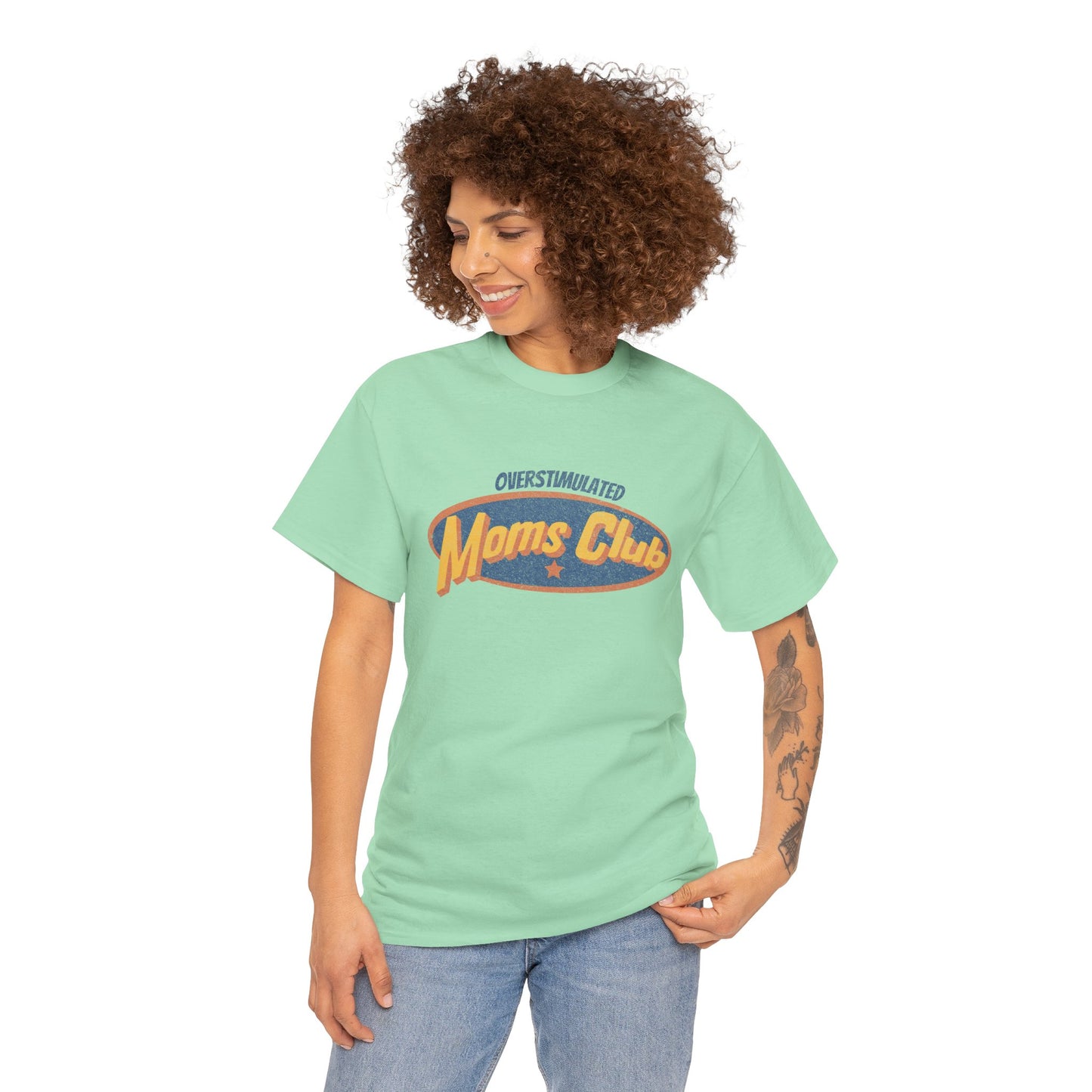 Woman wearing a light green t-shirt with 'Moms Club' text on a white background