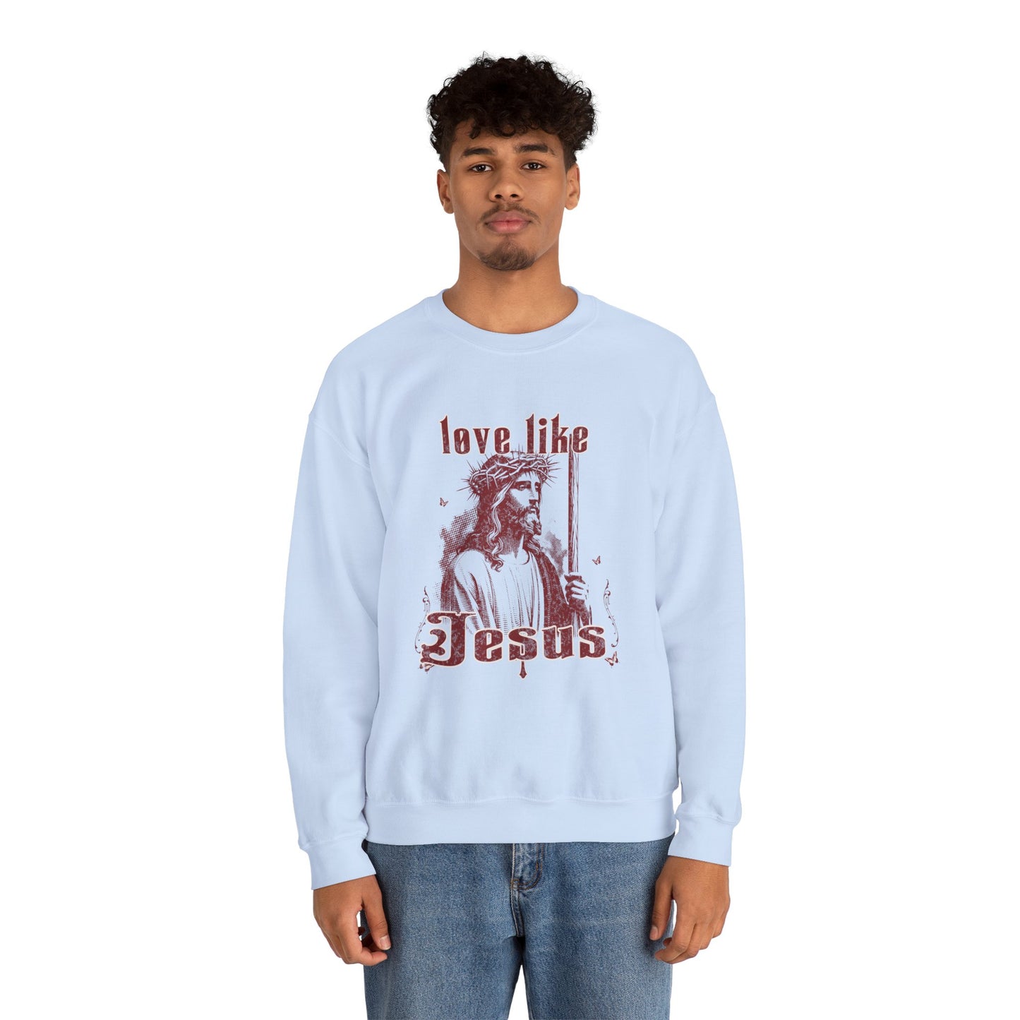 Light blue sweatshirt with 'Love like Jesus' graphic worn by a person on a white background