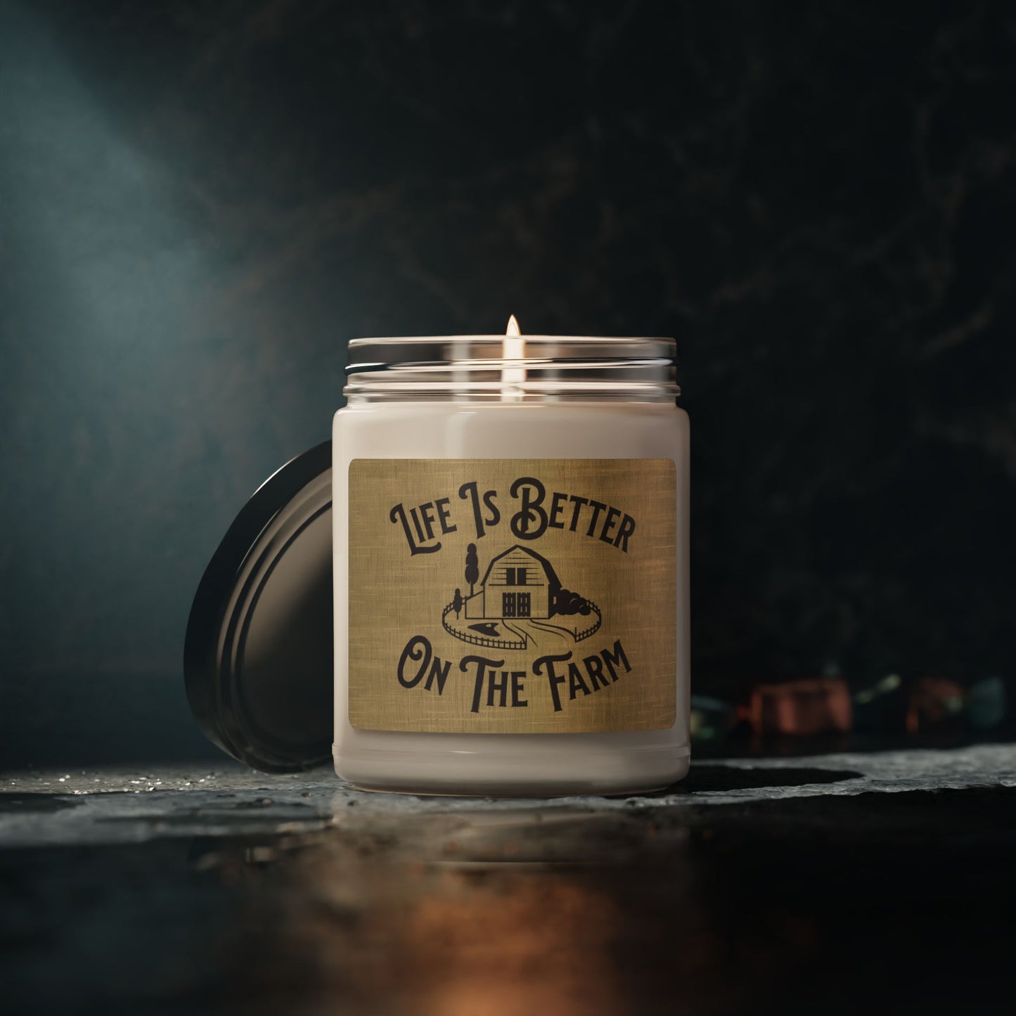 Country-inspired candle with barn graphic and rustic text