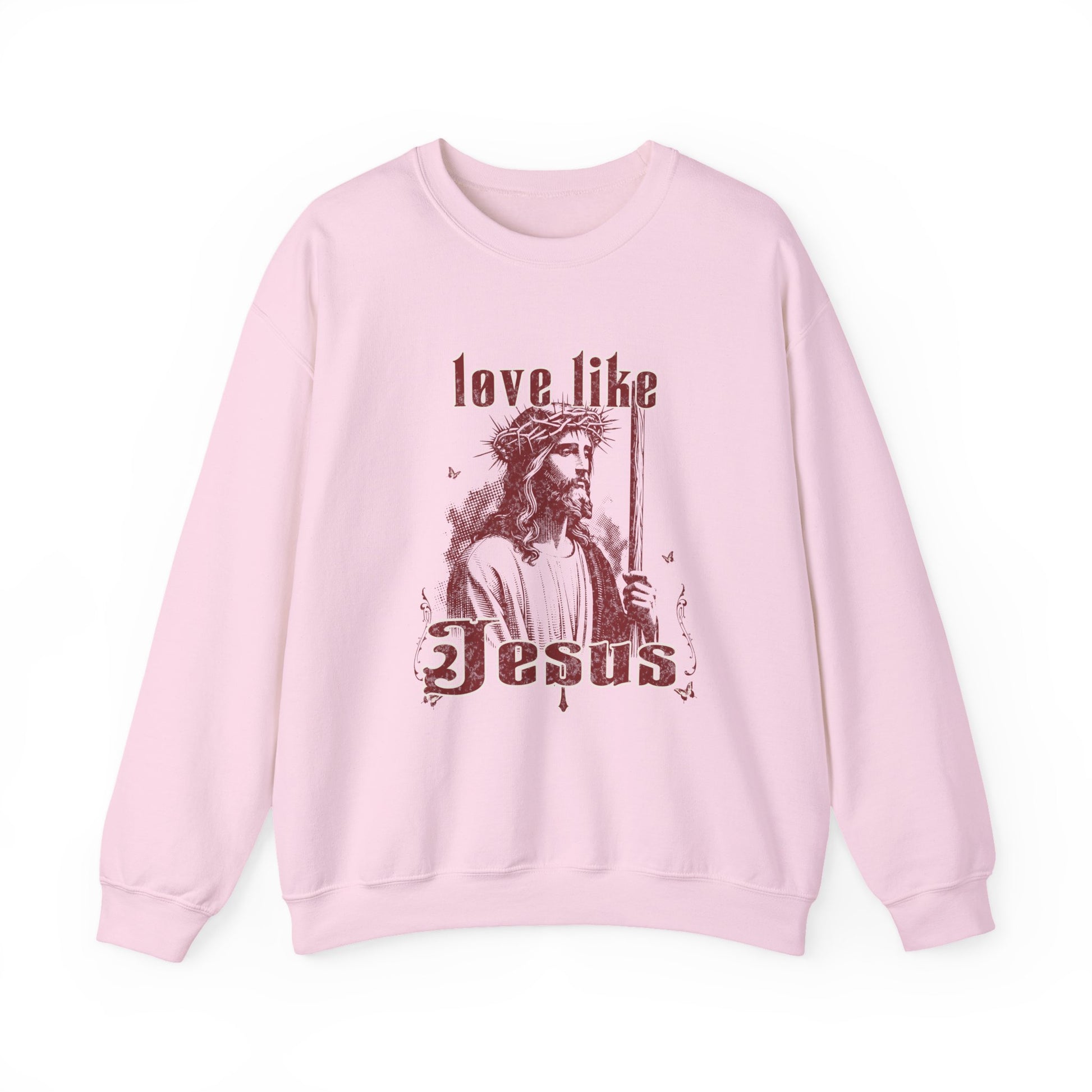 Pink sweatshirt with a graphic of a person holding a cross and text 'love like Jesus' on a white background