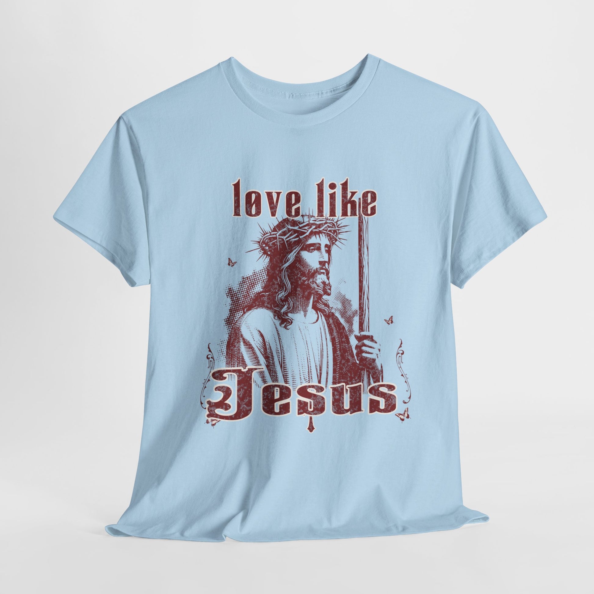 Light blue t-shirt with a graphic of a robed figure holding a staff and text 'love like Jesus' on a light gray background
