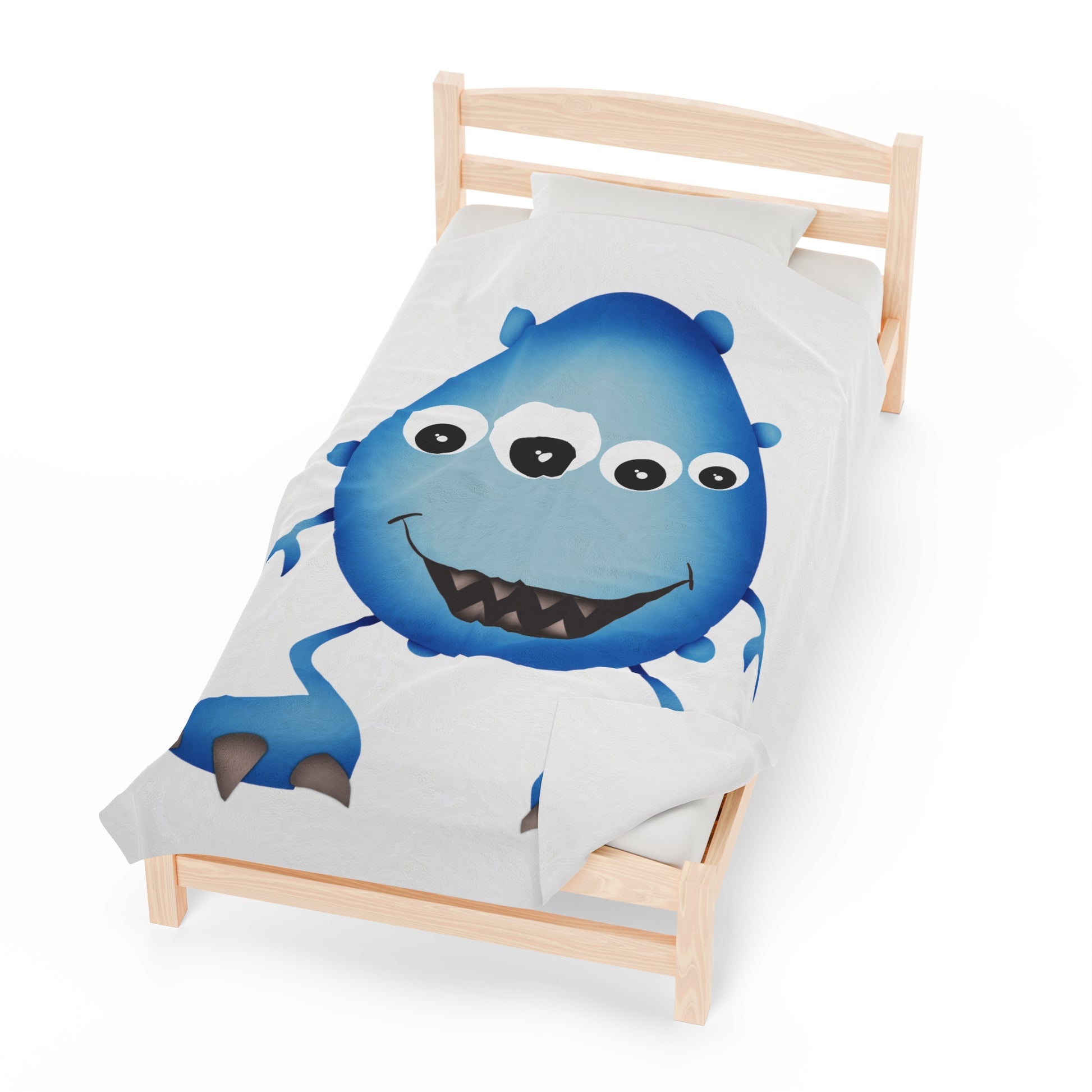 Cute Blue Monster Kids Plush Blanket draped over a child's bed.