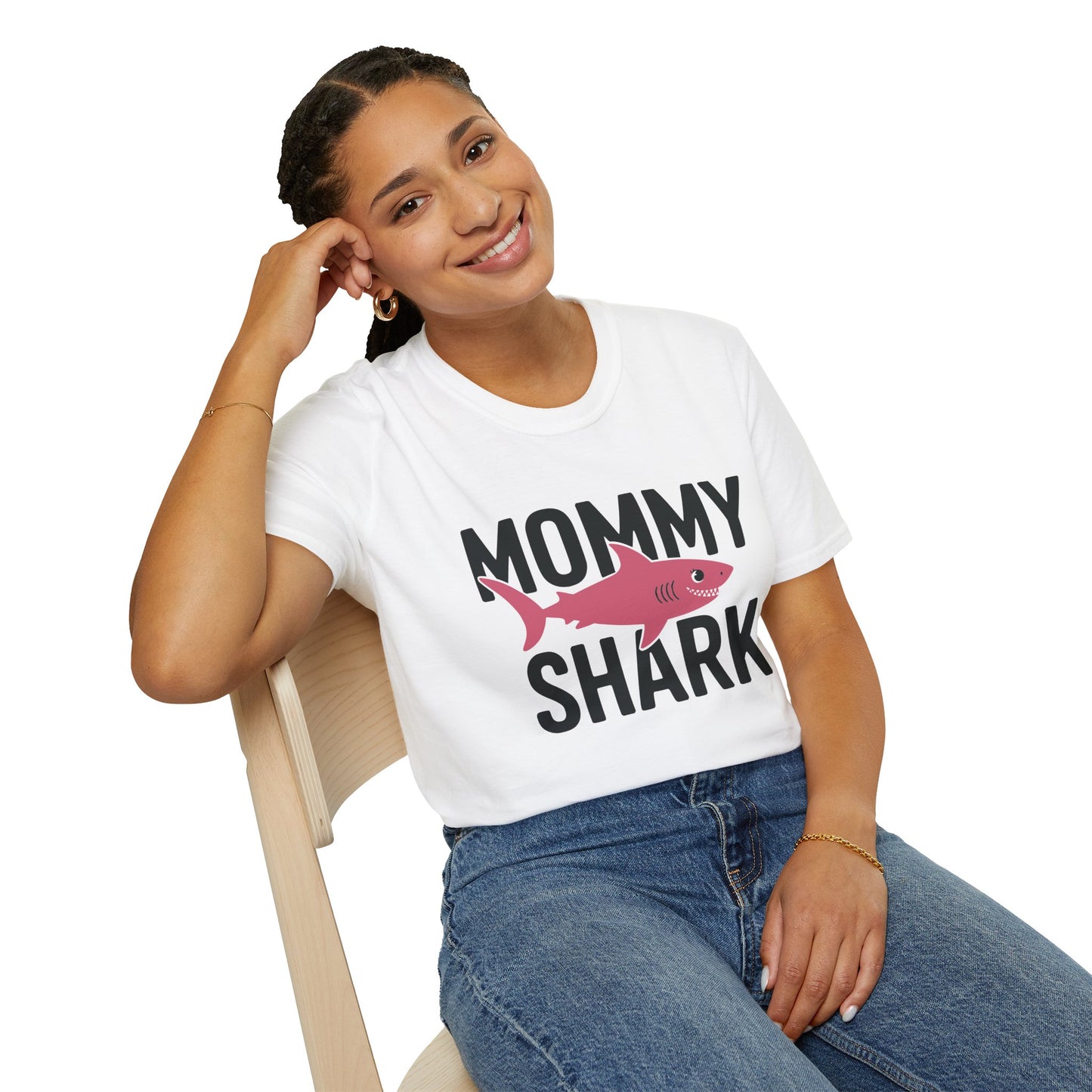 Woman wearing a 'Mommy Shark' t-shirt sitting on a chair.
