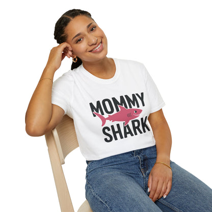 Woman wearing a 'Mommy Shark' t-shirt sitting on a chair.