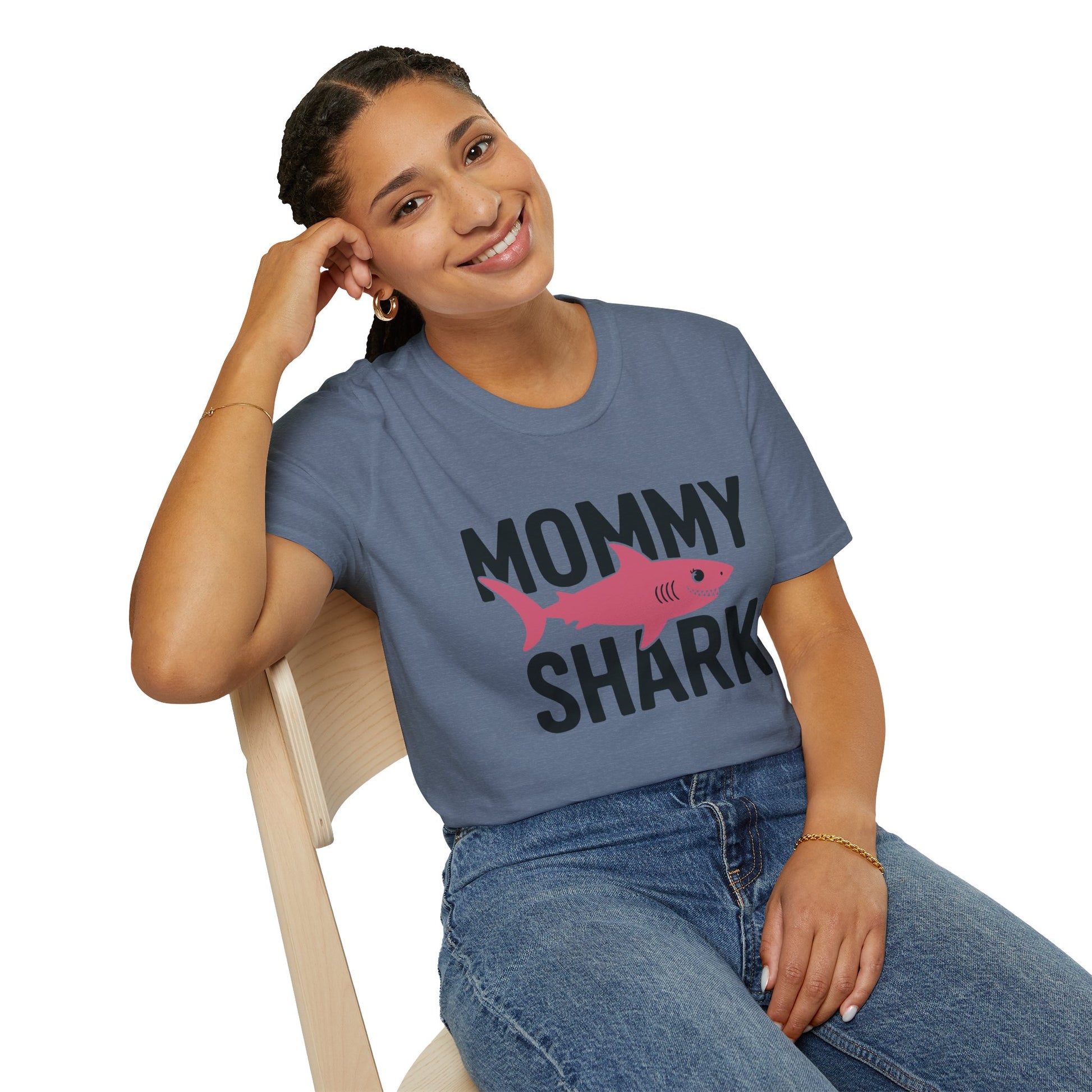 Woman wearing a 'Mommy Shark' t-shirt sitting on a chair.