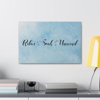 Relax Soak Unwind sign with soft blue watercolor background
