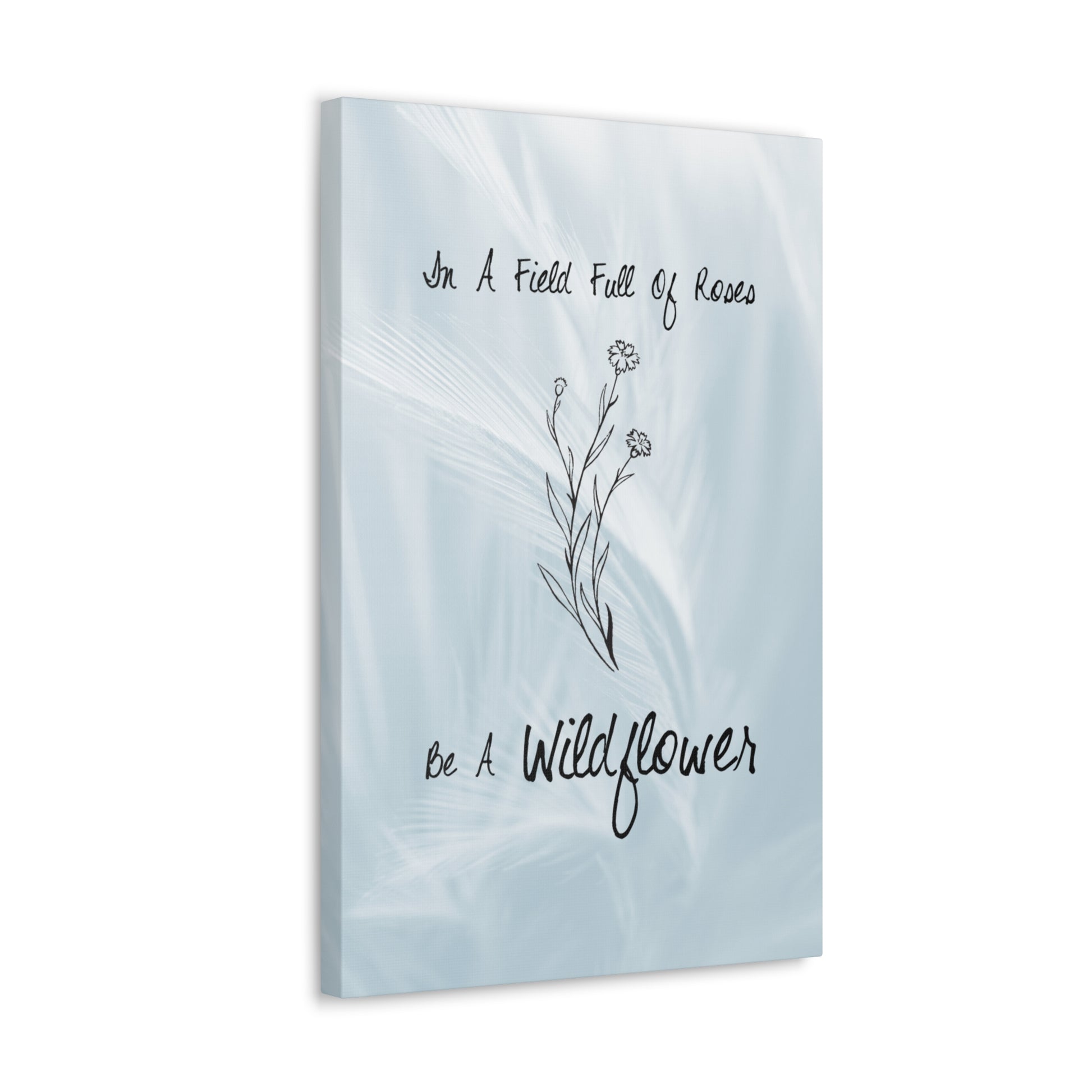 Close-up of floral canvas print with "Be a Wildflower" text
