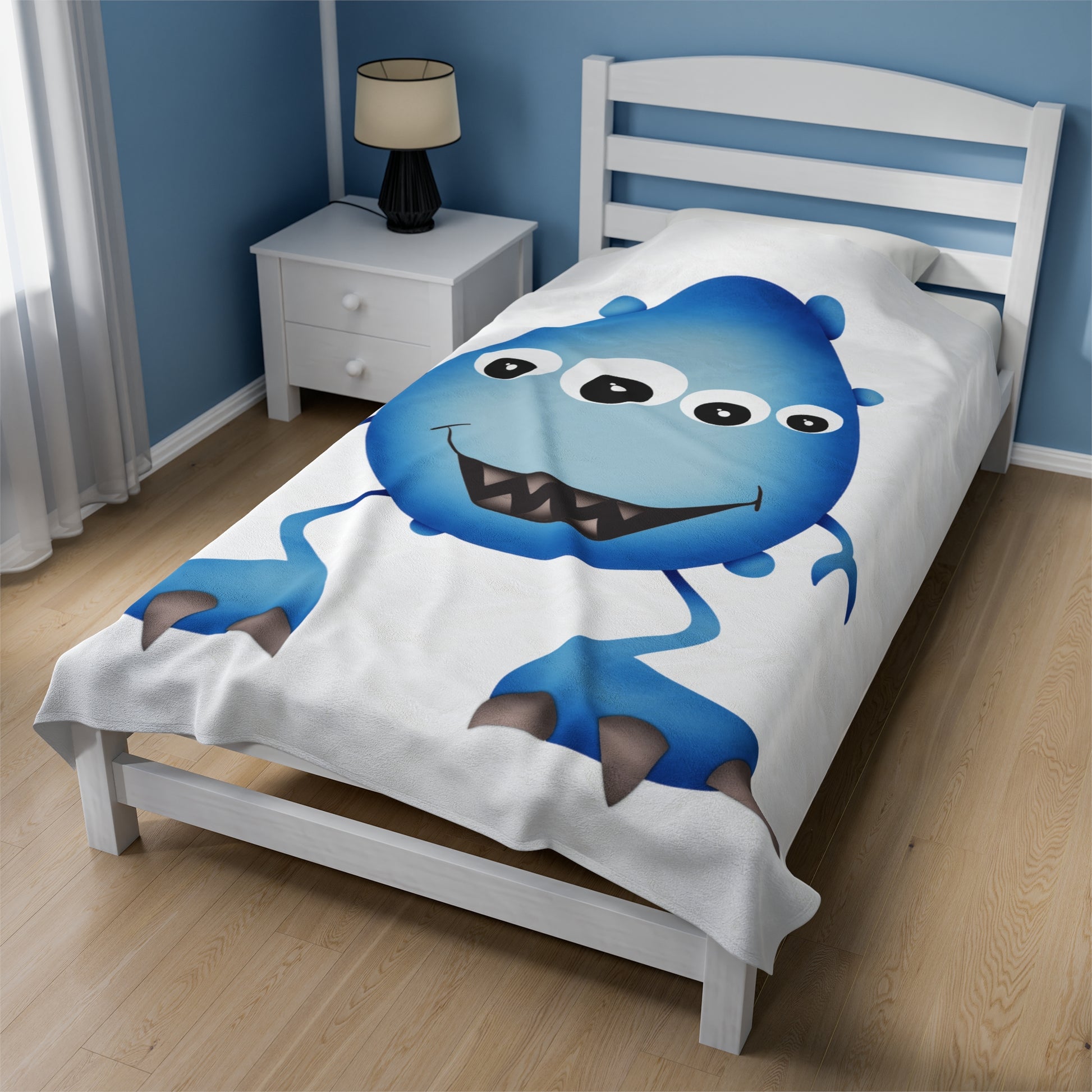 Vibrant blue monster blanket spread out on a bed.