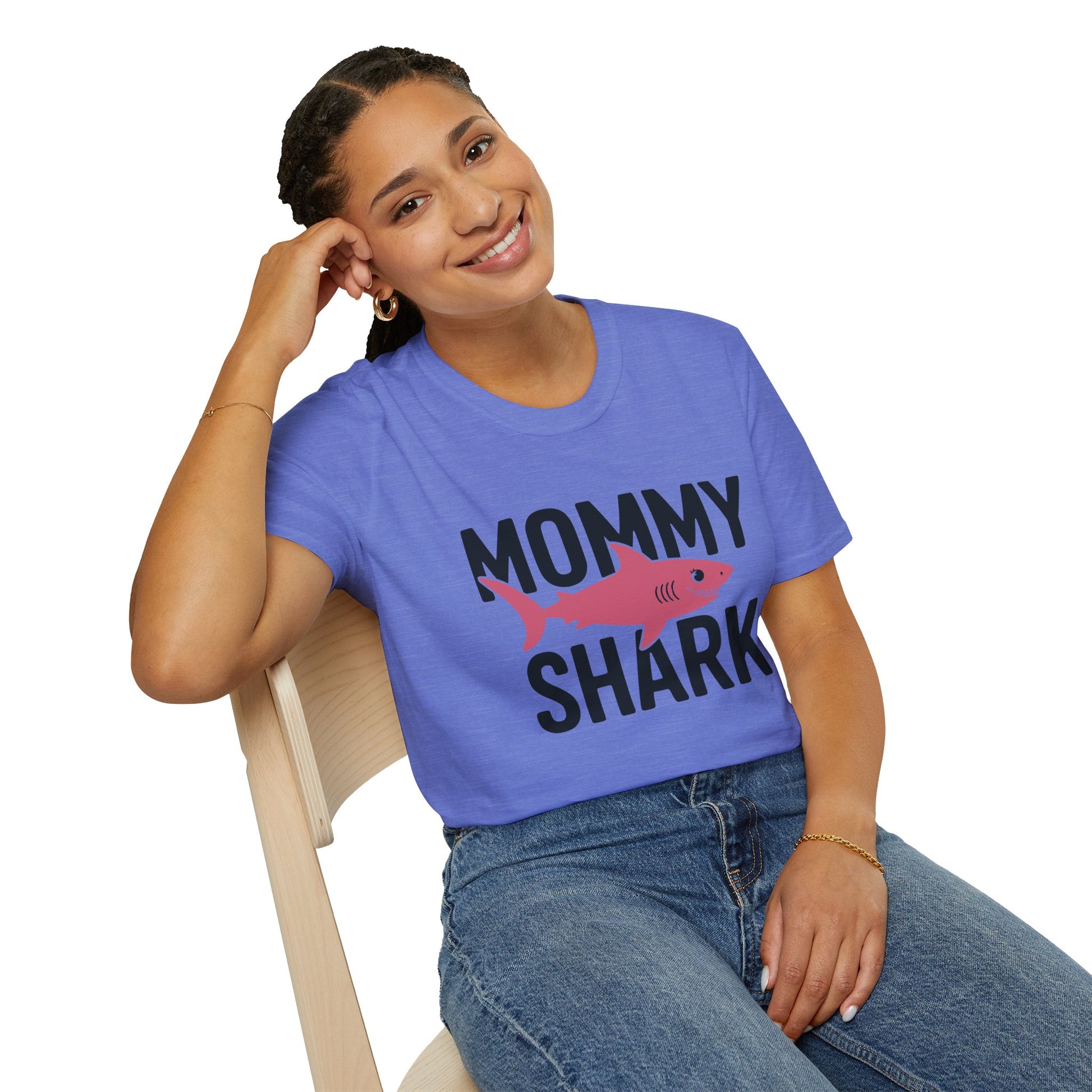 Woman wearing a purple 'Mommy Shark' t-shirt sitting on a chair.