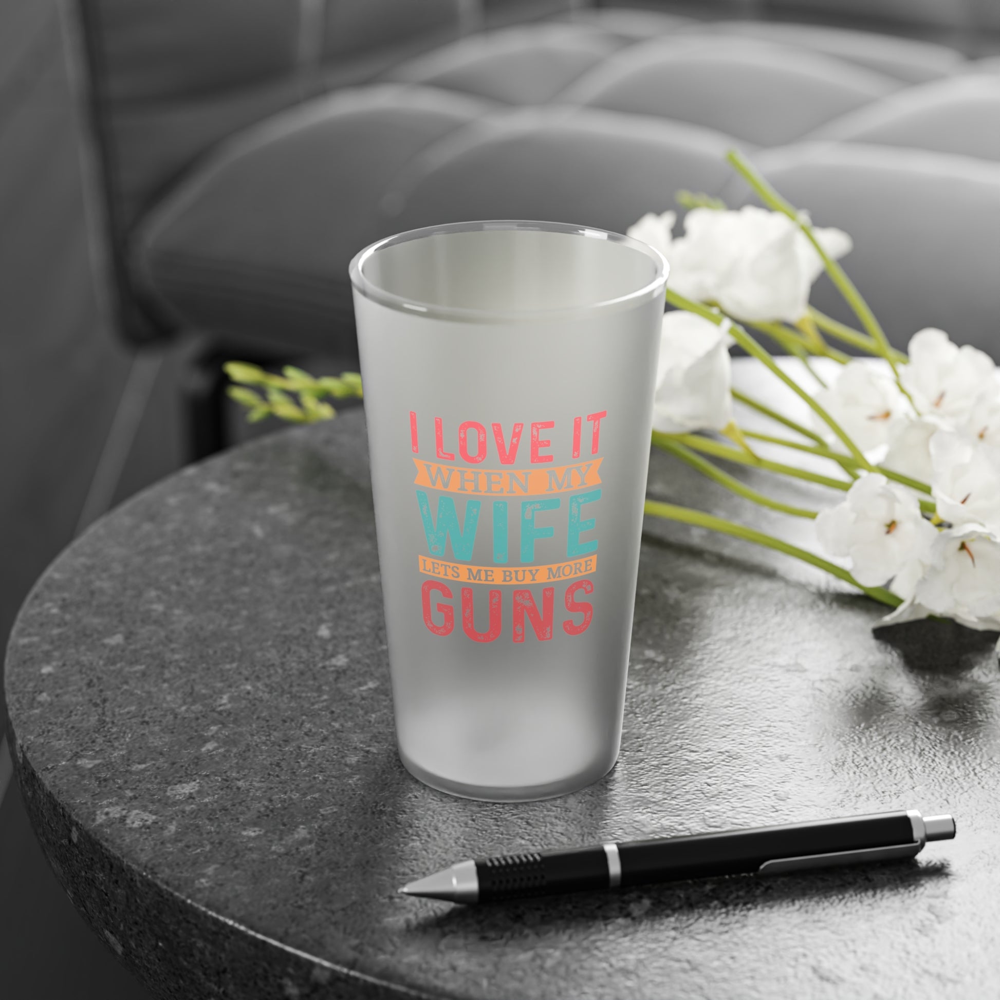 Pro-gun glass filled with beer on a rustic bar counter
