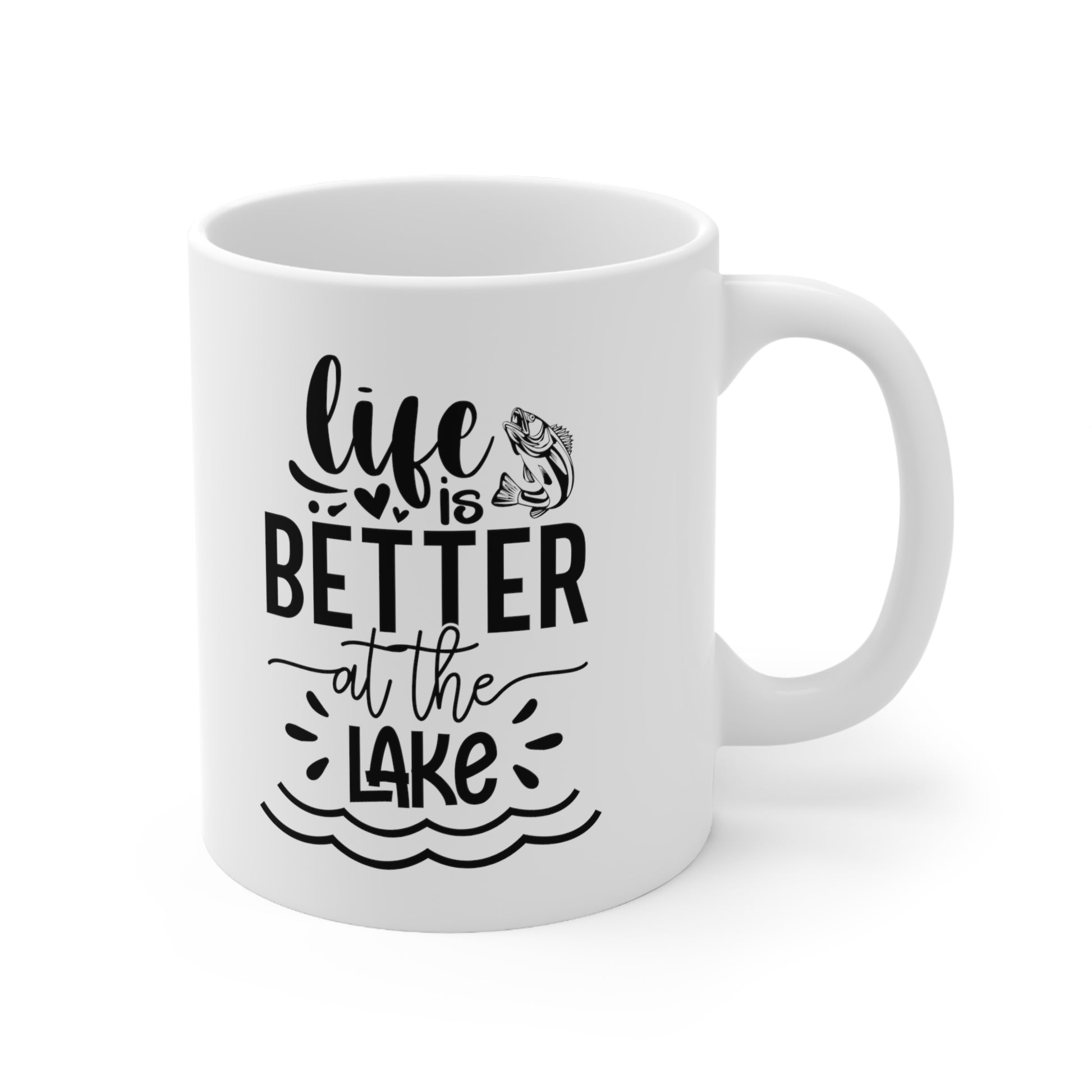Lake-themed coffee mug held by someone sitting near the water

