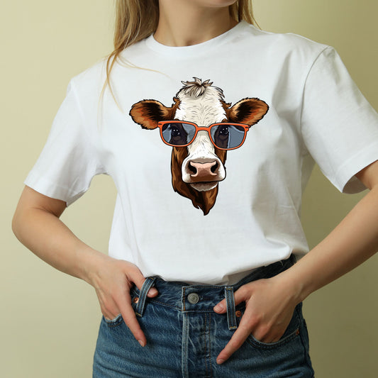 Women’s cow shirt featuring a brown and white cow wearing sunglasses.
