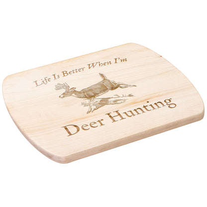 Hardwood cutting board with deer in woods design for hunters.