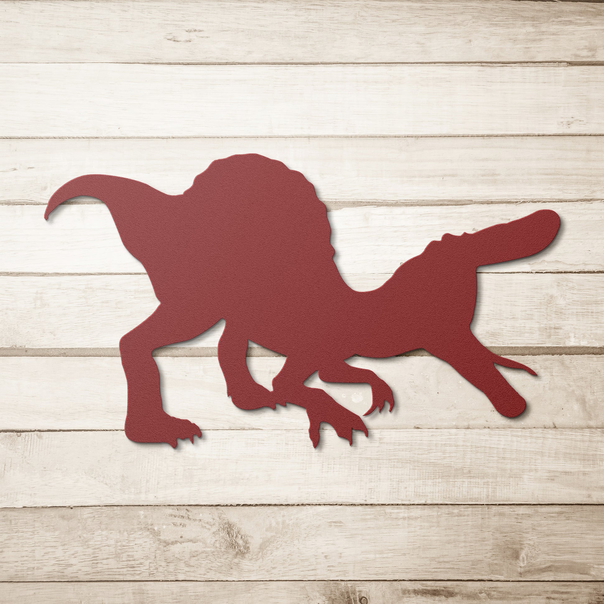 Red metal dinosaur cut-out for playful home accents.
