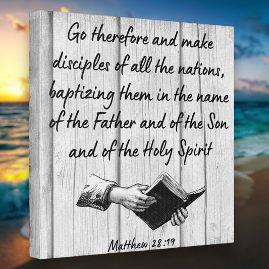 Bible verse wall art with Matthew 28:19 on a grey wooden background.
