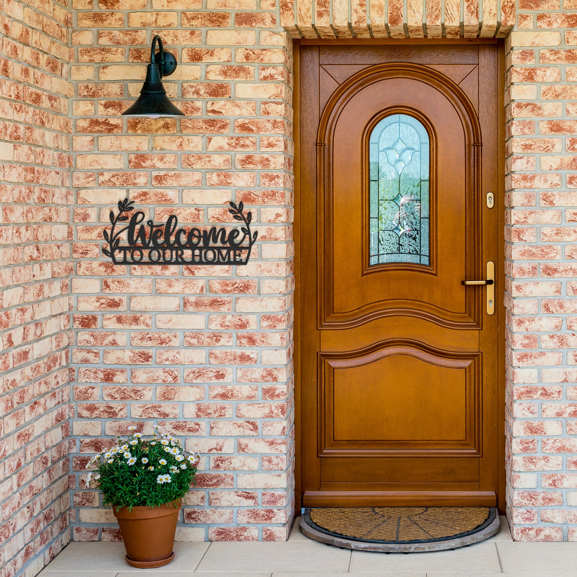 Black metal home sign featuring "Welcome to Our Home" text
