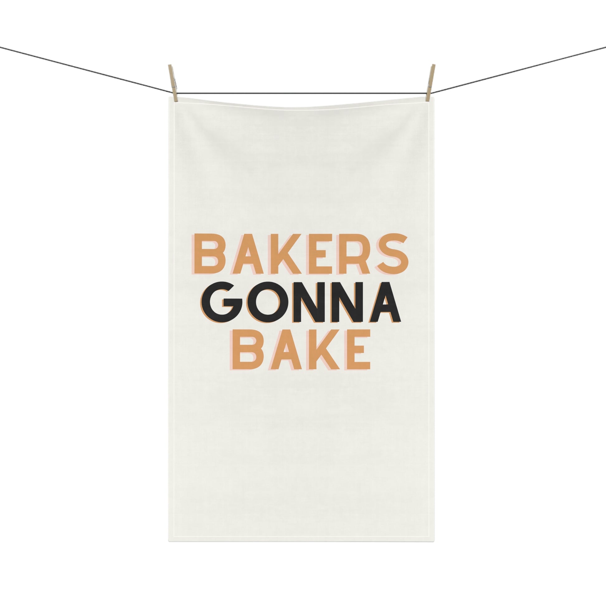 Folded cotton twill kitchen towel with baking motivational quote.