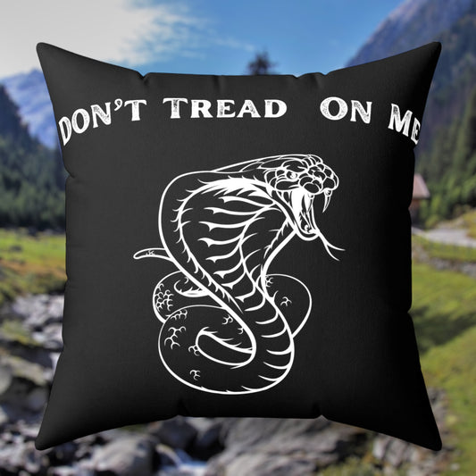 Black throw pillow with "Don’t Tread on Me" text and coiled snake design.
