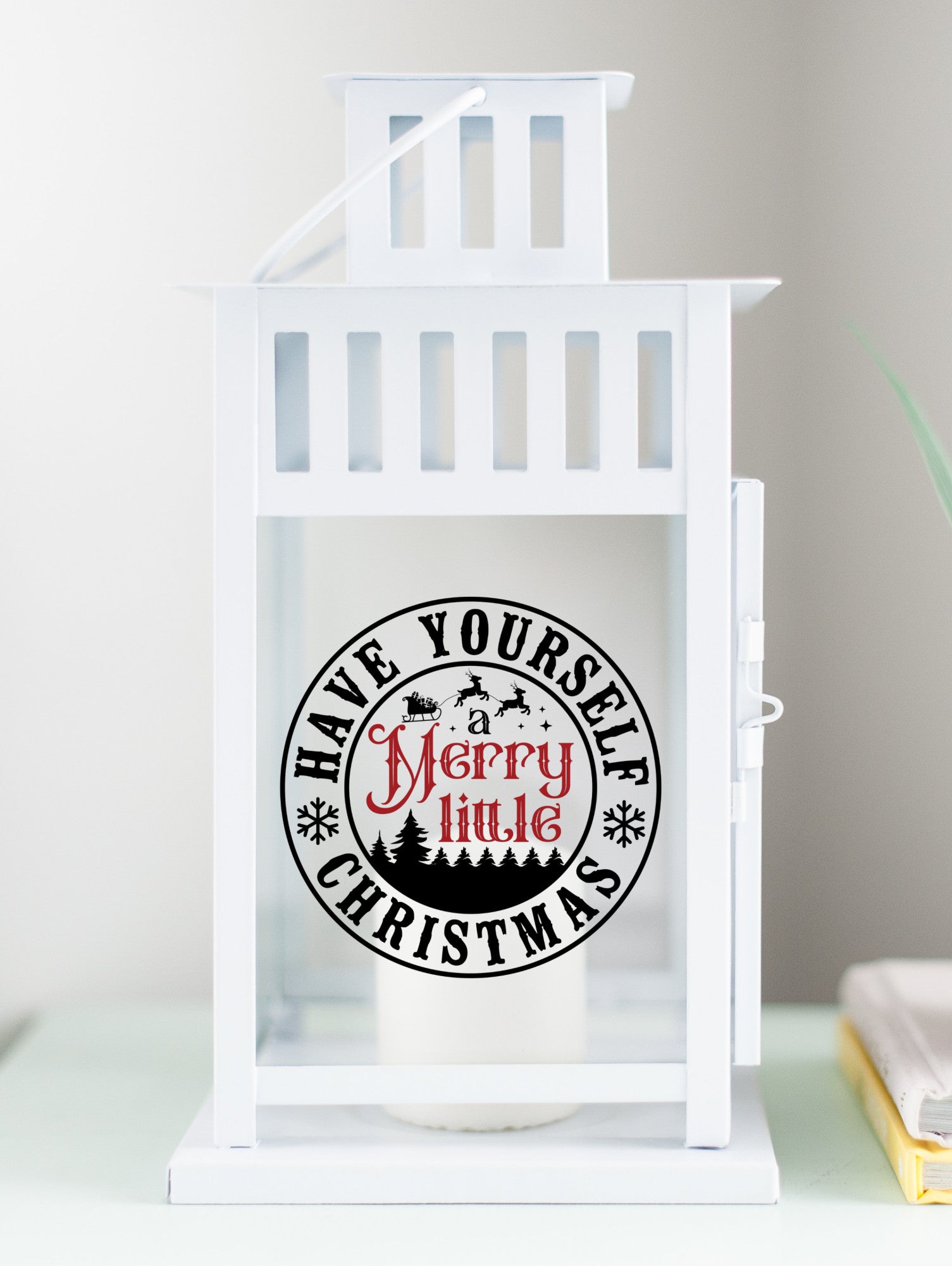 White Christmas decor lantern with "Have Yourself a Merry Little Christmas" text
